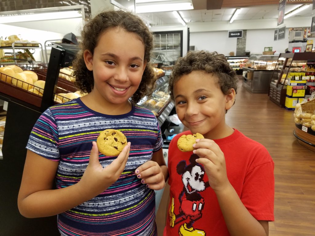 Kids eating Safeway Stores Cookie