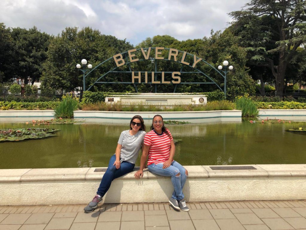 2 women in front of the Beverly Hills Sign