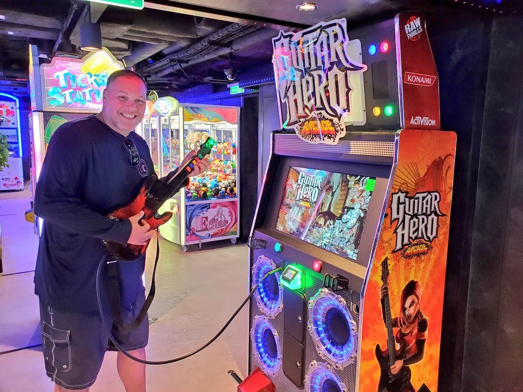 man playing arcade games